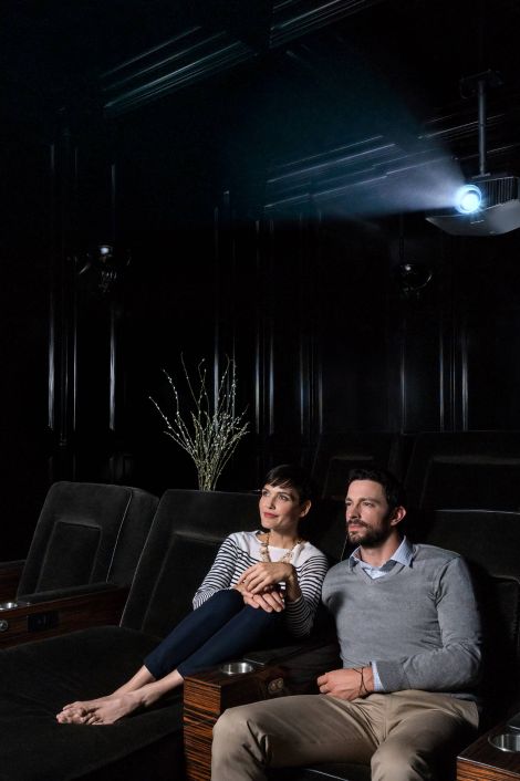 Couple watching a movie in a dark home theater